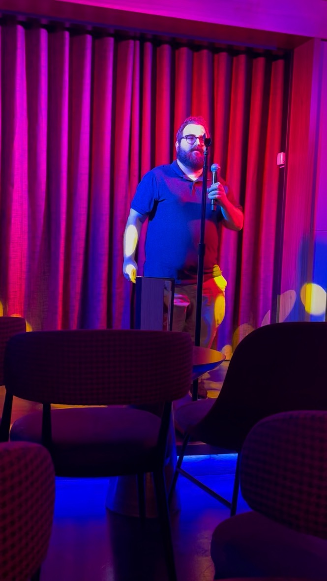 Kurt singing karaoke on stage